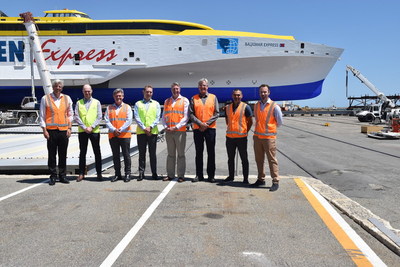 Darren Larkins and Simon Crook of SSI meet with Patrick Gregg, Gordon Blauw, Ben Wardle, and others from Austal in front of the 118m trimaran Bajamar Express.